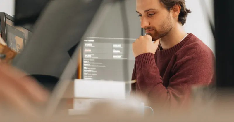A Setsail Marketing strategist thinking through a plan at his desk