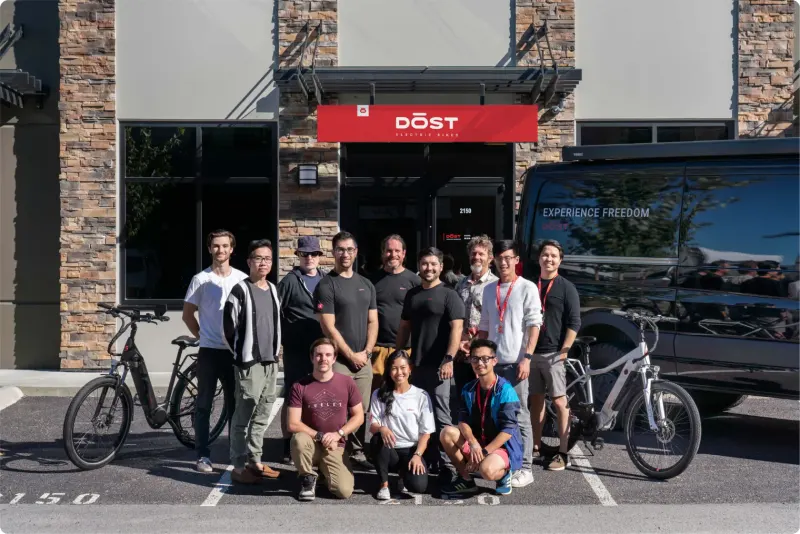 The DŌST team with their e-bikes outside the DŌST storefront
