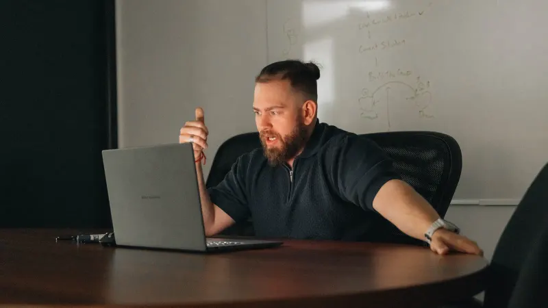 A Setsail strategist talking through a plan at a laptop in a meeting room.