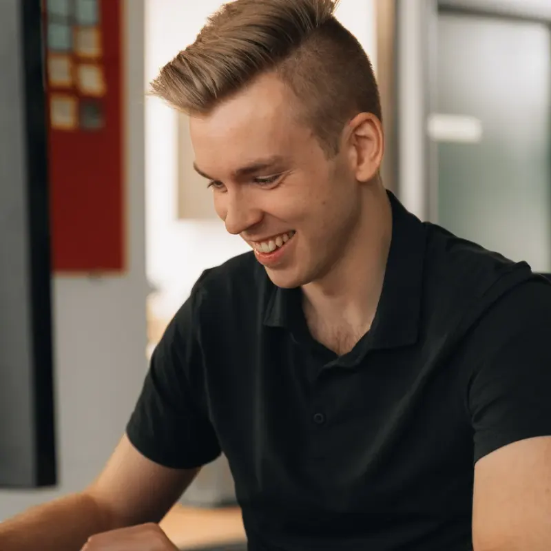 A Setsail strategist smiling at his desk in the Vancouver studio